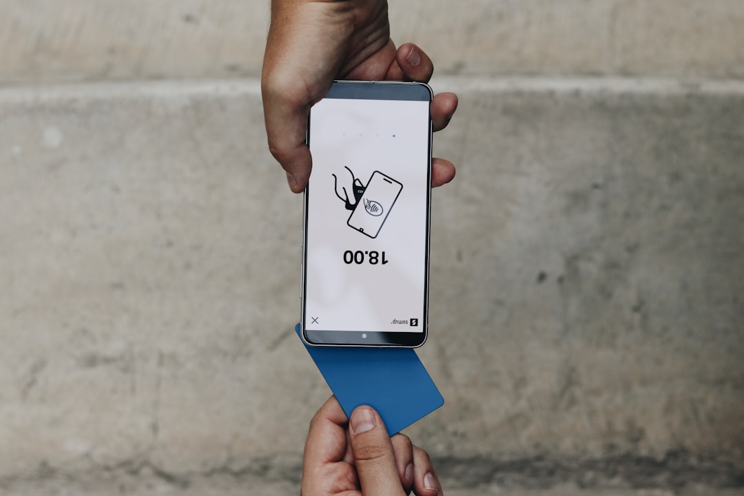 A person holding a box with a cat on it