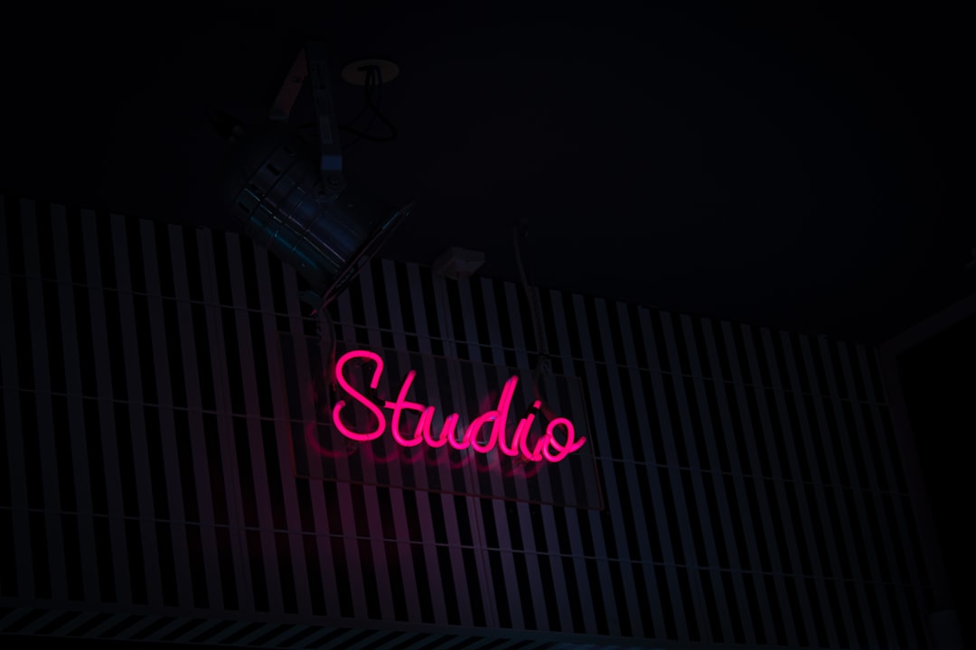 A cute 3D isometric illustration of a glowing music studio with floating musical notes around a small AI orb on a clean desk, soft pastel pink and lavender palette, sparkles, Pixar quality 8K, no text