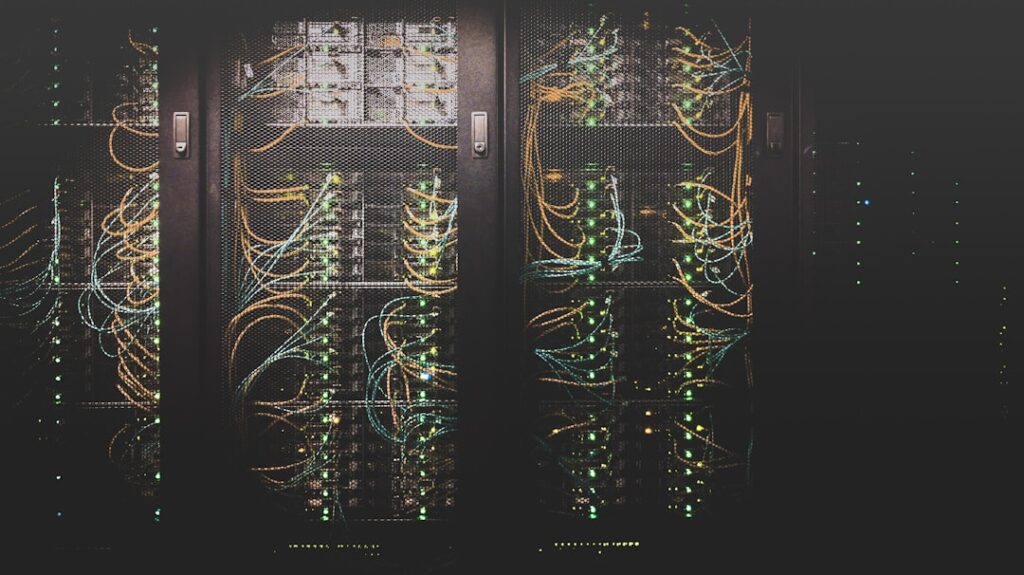AMD 베니스 - Cinematic data center server rack with rows of glowing CPU sockets, blue LED lighting, holographic performance g...